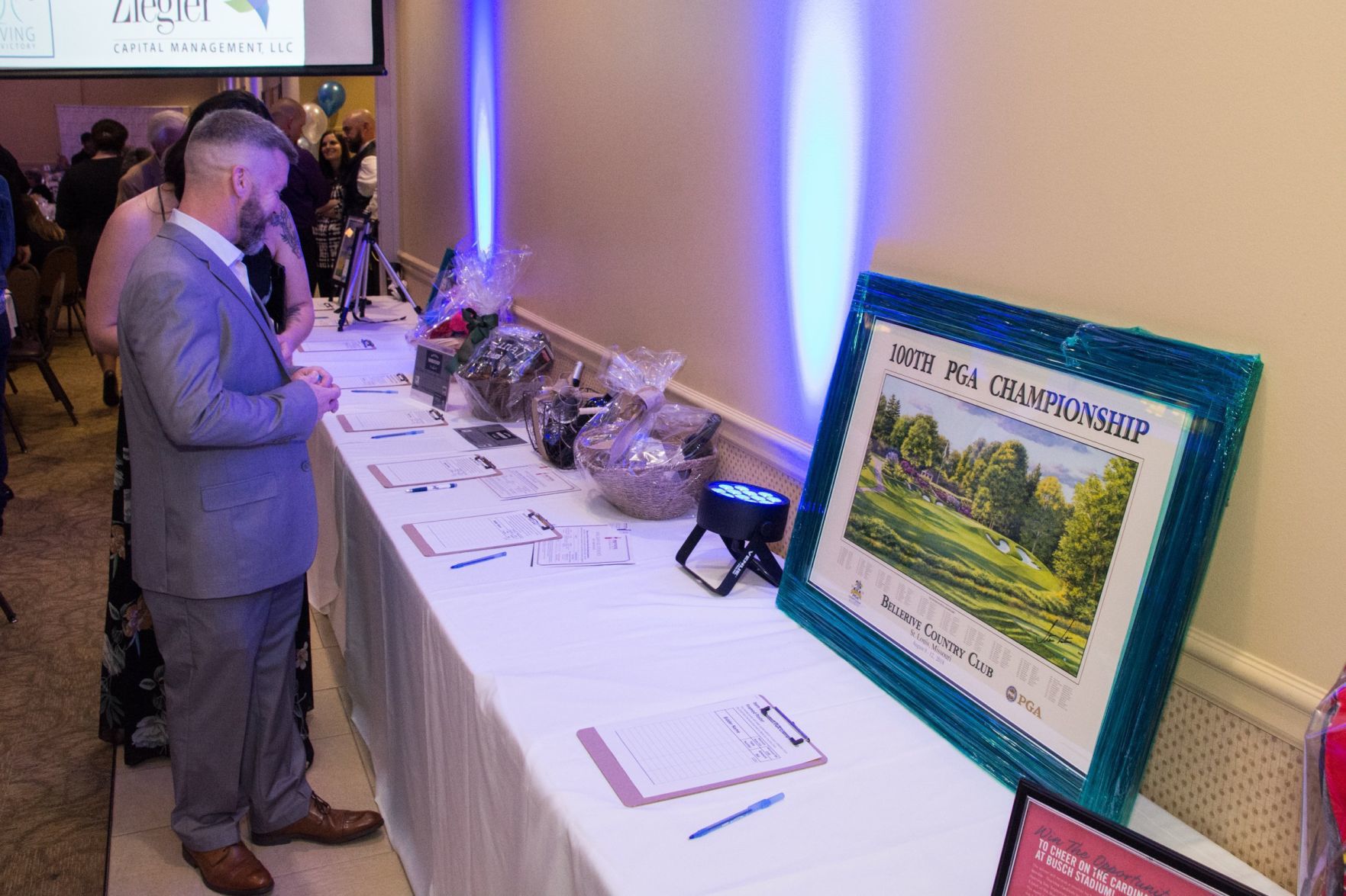 Attendees look at silent auction items